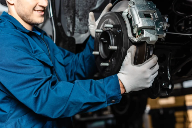 Mechanic installing a brake disc on a vehicle.